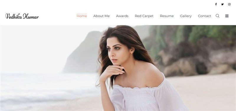 Archived Vedhika Kumar portfolio homepage with a large portrait hero and biography section.